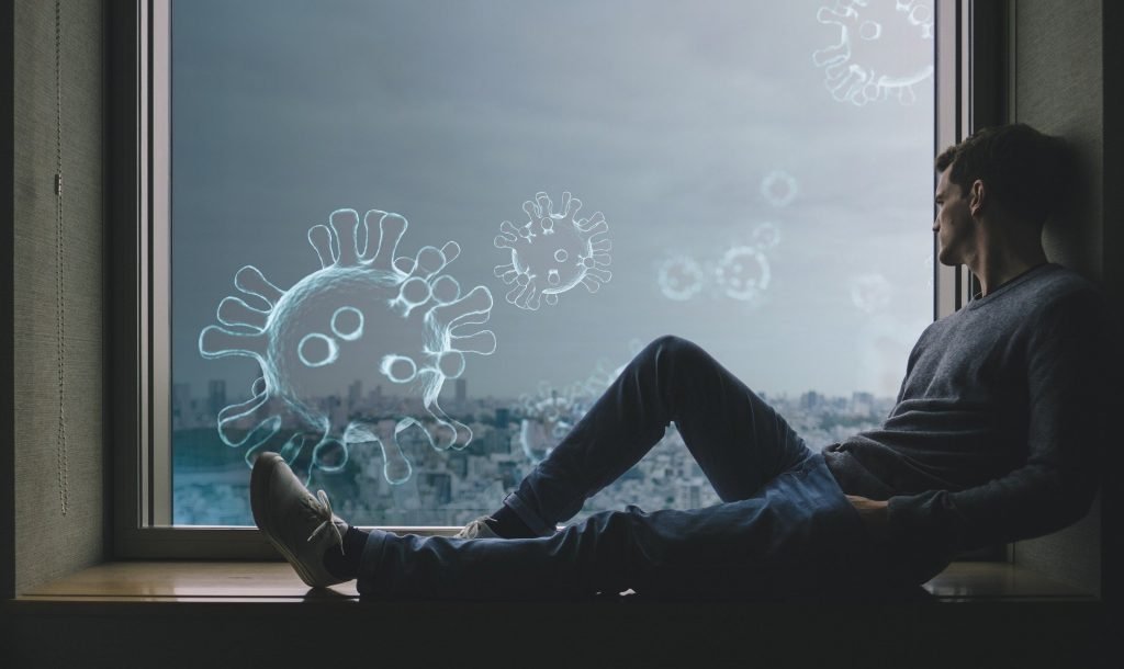 man looking at bacteria particles out of the window