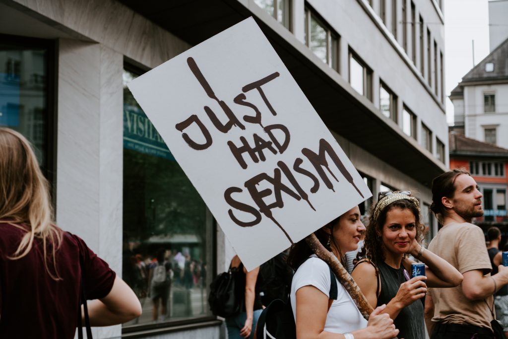 Woman holding I Just Had Sexism placard