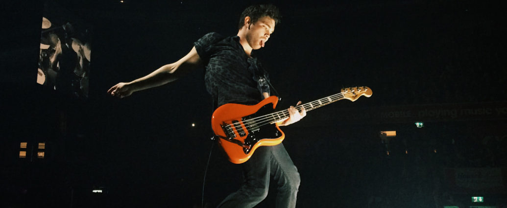 Royal Blood's guitarist Mike Kerr playing a guitar on stage