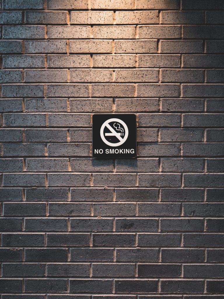 No smoking sign on brick wall