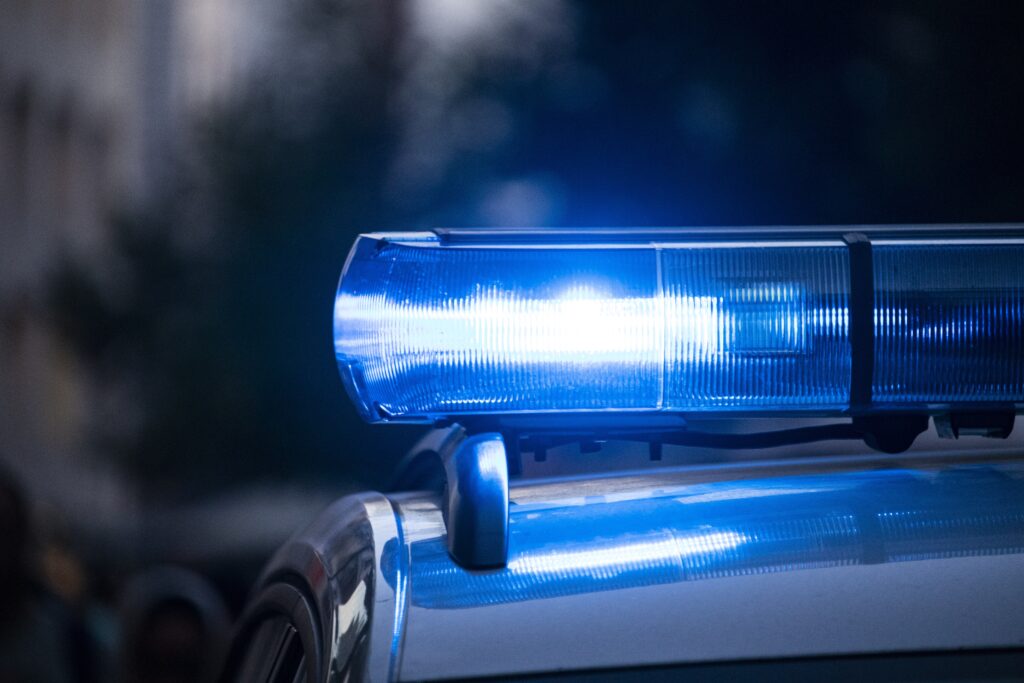 A blue light glowing on top of a police car