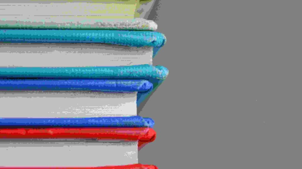 a stack of colourful books representing the studying students will do for their gcses