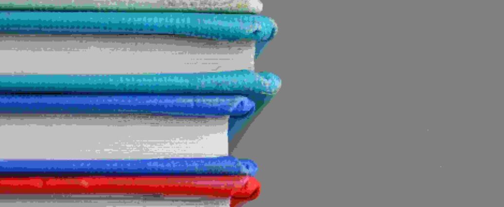 a stack of colourful books representing the studying students will do for their gcses