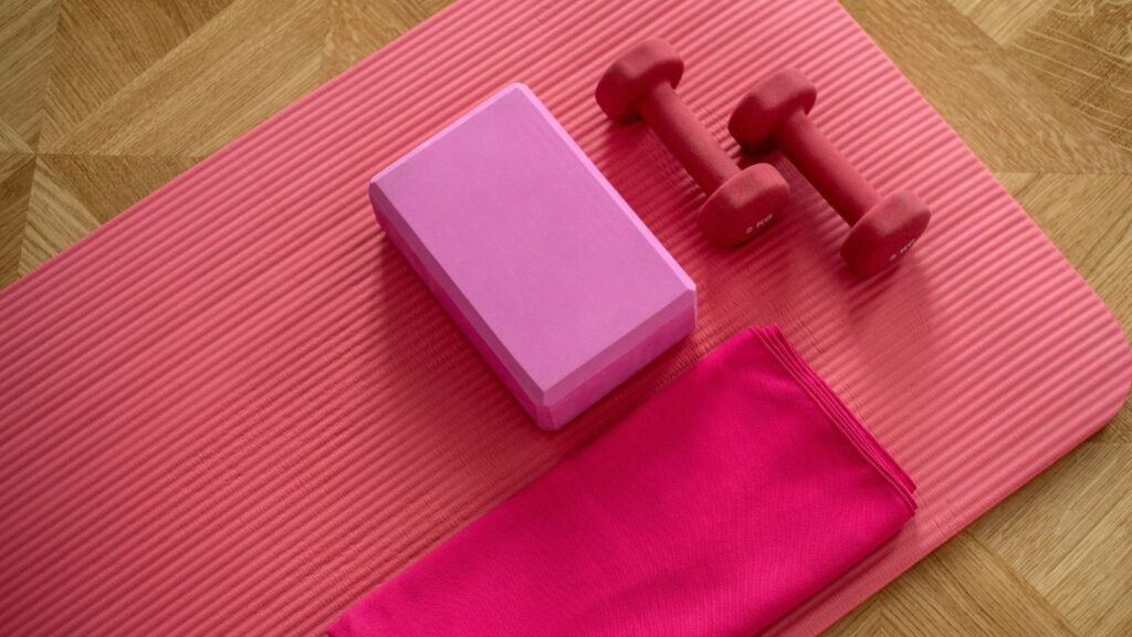 Pink exercise mat and weights.