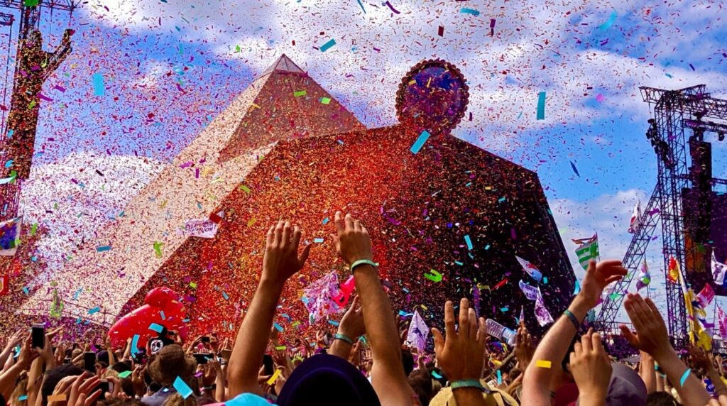 Confetti and crowds in front of Glastonbury's Pyramid Stage - the setting of this year's showdown between Rina Sawayama and Matty Healy