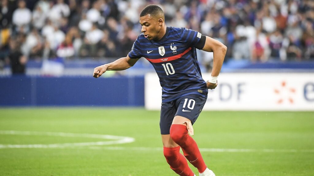 Kylian mbappe kicking a football