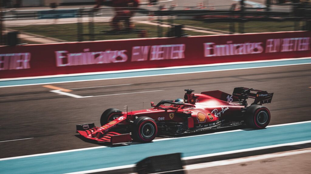 Charles Leclerc's ferrari racing down a straight on a formula one track