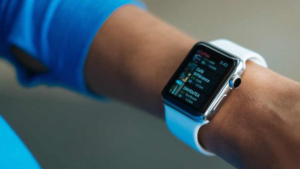 Image shows an outstretched arm sporting an Apple Watch, a device that is commonly used to track 10,000 steps