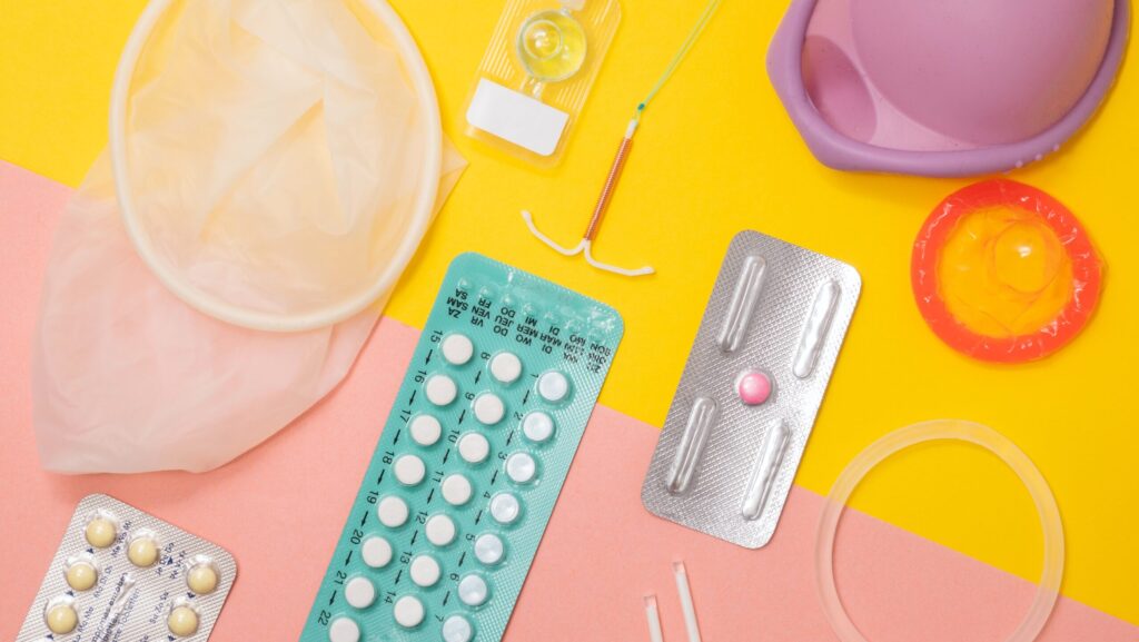 Image displays various methods of contraception, including a dental dam, condom, IUD and various pills.