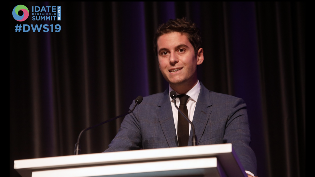 Gabriel Attal speaking at a podium