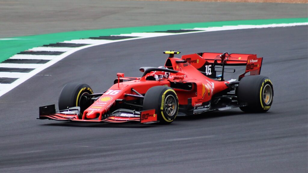 Image shows a red formula 1 car on a racing track.