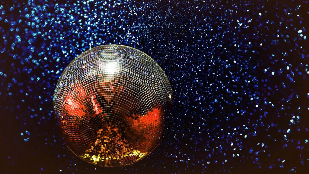 silver disco ball on sparkly starry backdrop