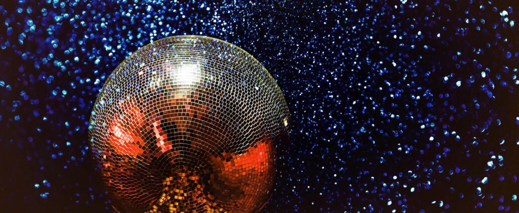 silver disco ball on sparkly starry backdrop