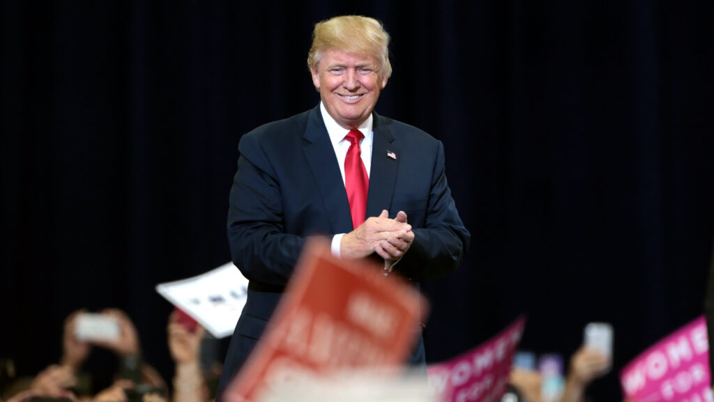 Donald Trump surrounded by Republican supporters.