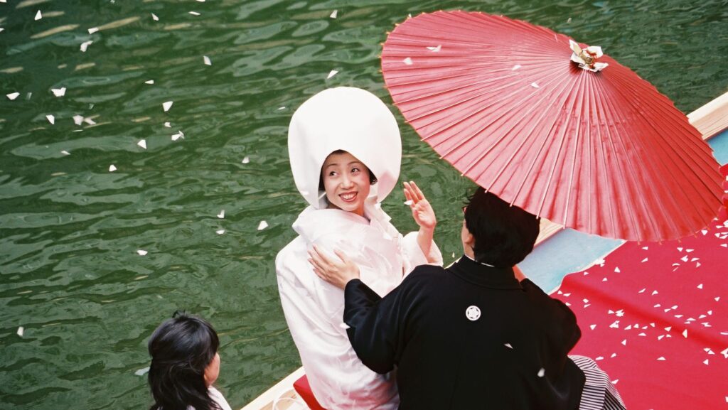 Japanese bride celebrates on a boat on her wedding day. [Japanese law married surnames]