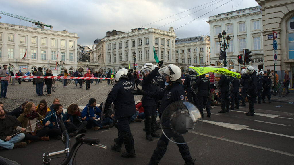 Police approach sitting protestors at an Extinction Rebellion public demonstration, 2019.