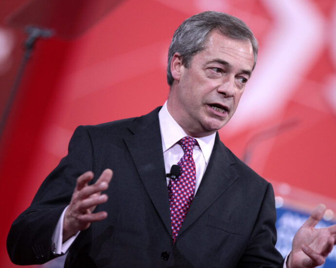 Nigel Farage speaks at a conference. Will the new Reform UK leader make any difference for the residents of Clacton?