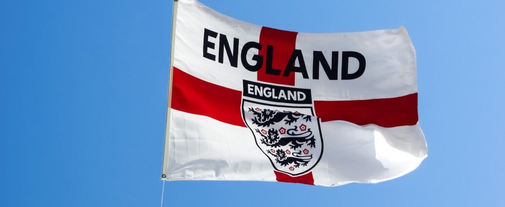 England flag (Red Cross over white) with English football team logo on it against blue sky