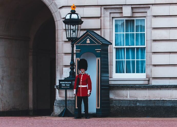 Royals guard standing beside building