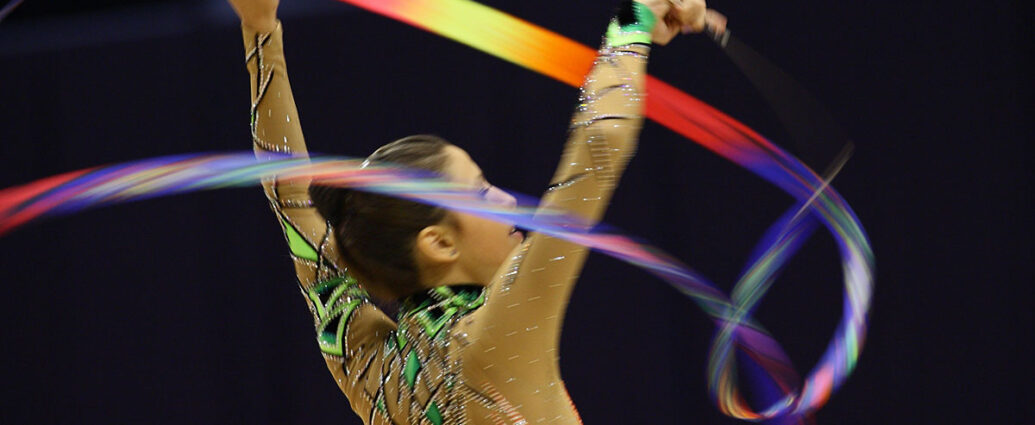 female gymnast flinging colourful ribbon. women in the olympics