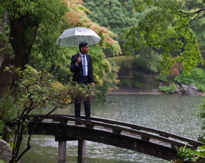 Rishi Sunak stands in the rain with an umbrella. The UK said goodbye to Sunak as its PM after the landslide achieved by Labour in the General Election 2024