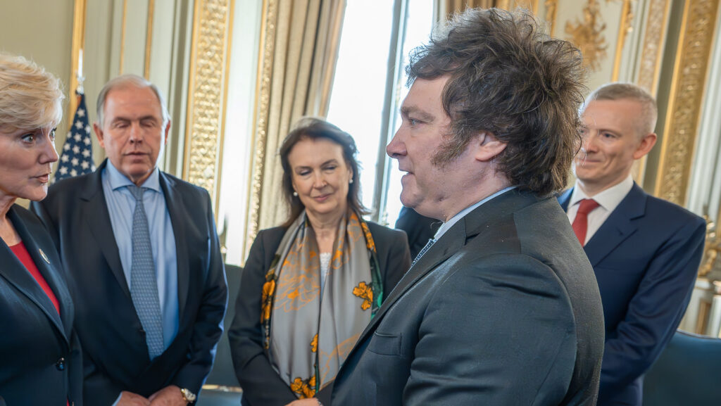 Image of Argentinian PresidentJavier Milei with other Argentinian government officials in suits.