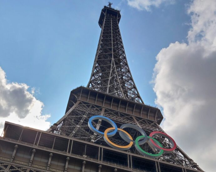 Blue, green, red, yellow and black Olympic rings on the Eiffel Tower representing 2024 Olympic records