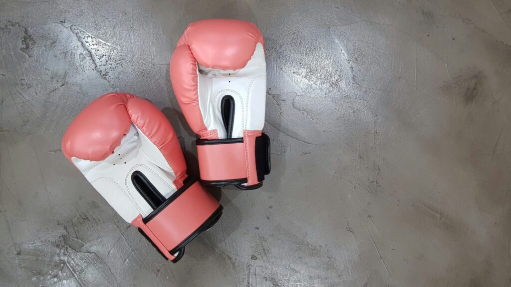 A pair of pink boxing gloves. The Paris Olympics boxing has shown that transphobia and misinformation are alive and well