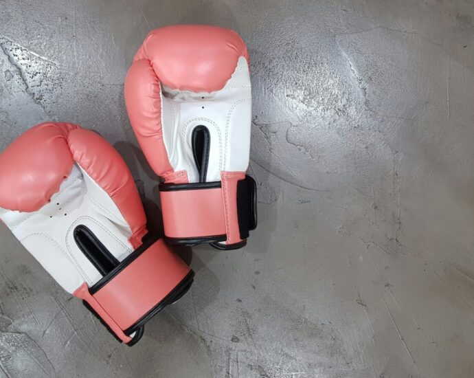 A pair of pink boxing gloves. The Paris Olympics boxing has shown that transphobia and misinformation are alive and well