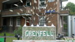 a Grenfell memorial outside brown building made from green and white mosaic tiles.