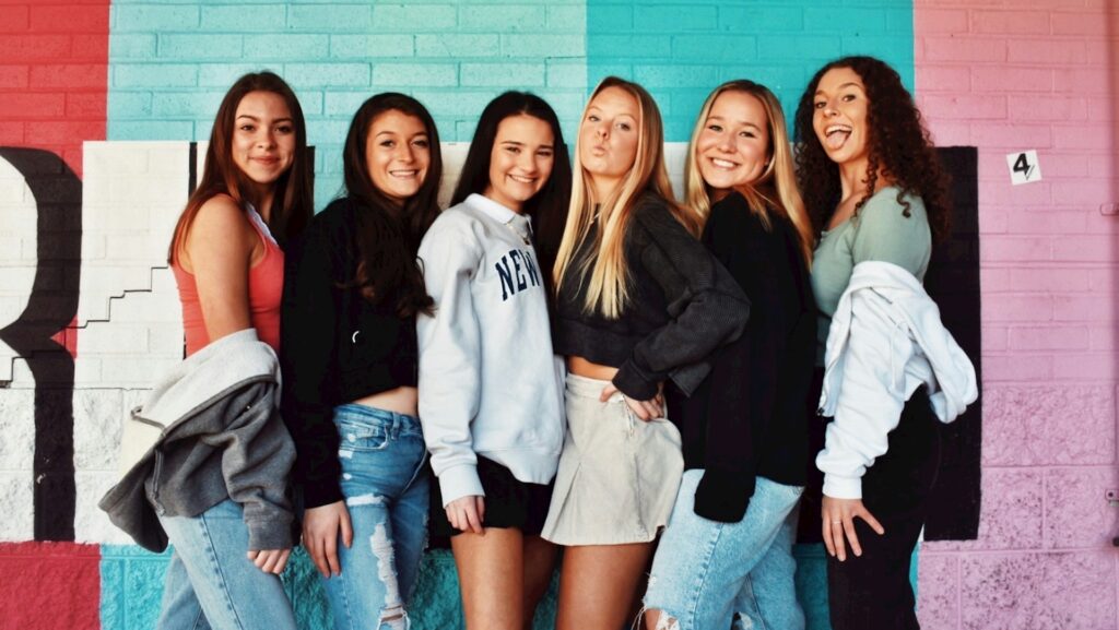 A group of teenage girls wearing denim and jumpers