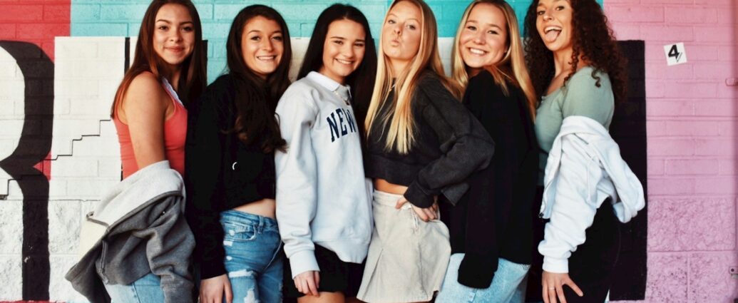 A group of teenage girls wearing denim and jumpers