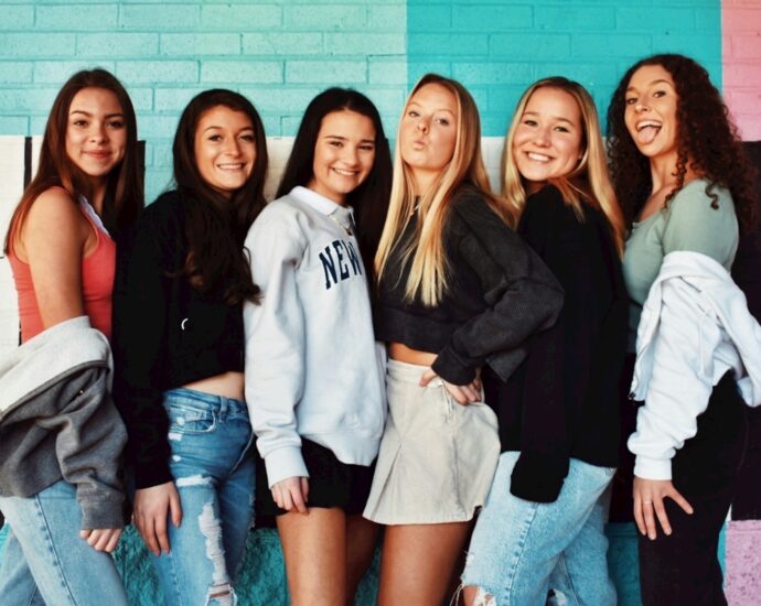 A group of teenage girls wearing denim and jumpers