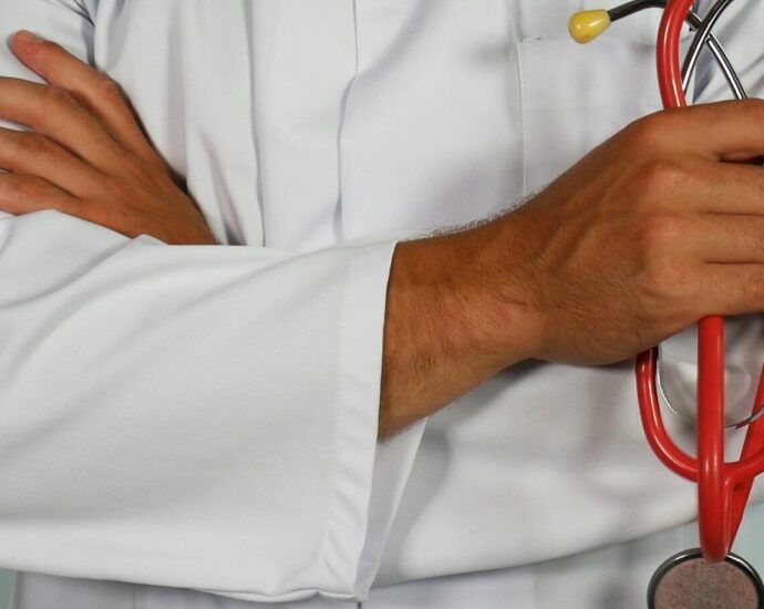 a health professionals wearing white medical jacket holding stethoscope