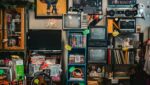 a room filled with random items of old media including a tv, radio and books