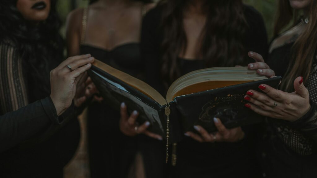 a group of four girls holding a book