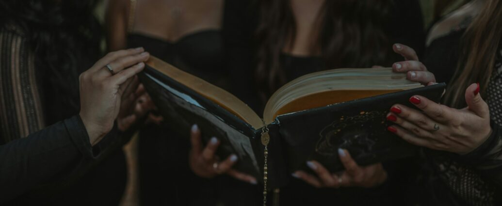 a group of four girls holding a book