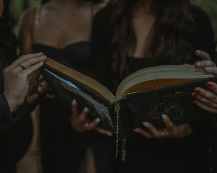 a group of four girls holding a book