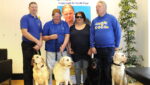 Guide Dogs with their owners at an event