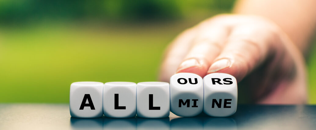 A hand turns the last two dice in a row of five, changing the expression "all mine" to "all ours".
