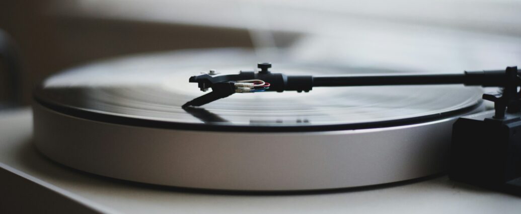 Black and white photo of a turntable promoting a review of a new single by Celeste