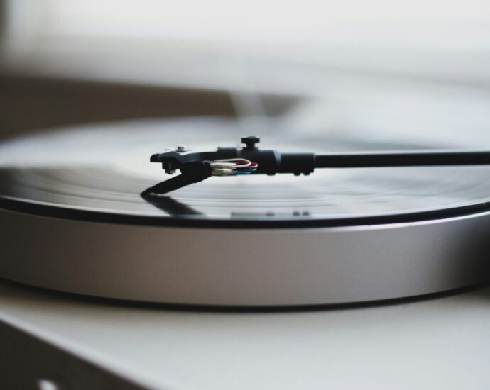 Black and white photo of a turntable promoting a review of a new single by Celeste