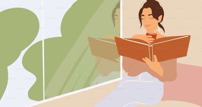 Woman reading by window getting through 2025 TBR pile