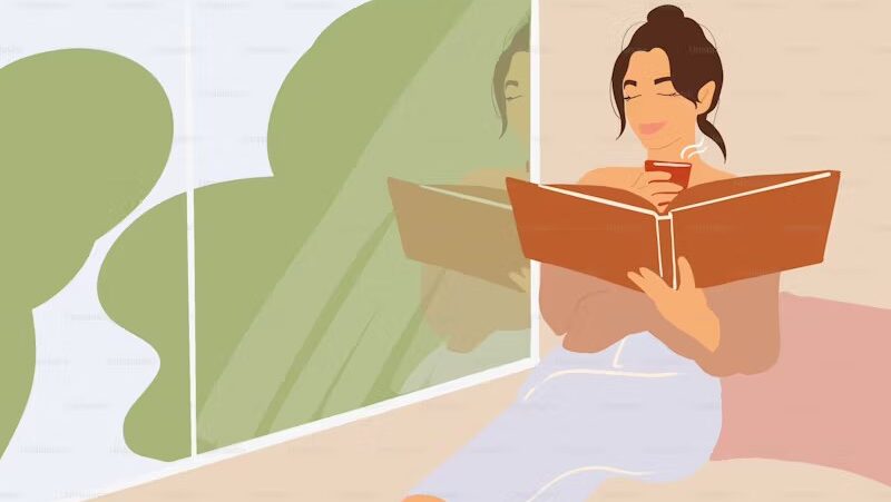 Woman reading by window getting through 2025 TBR pile