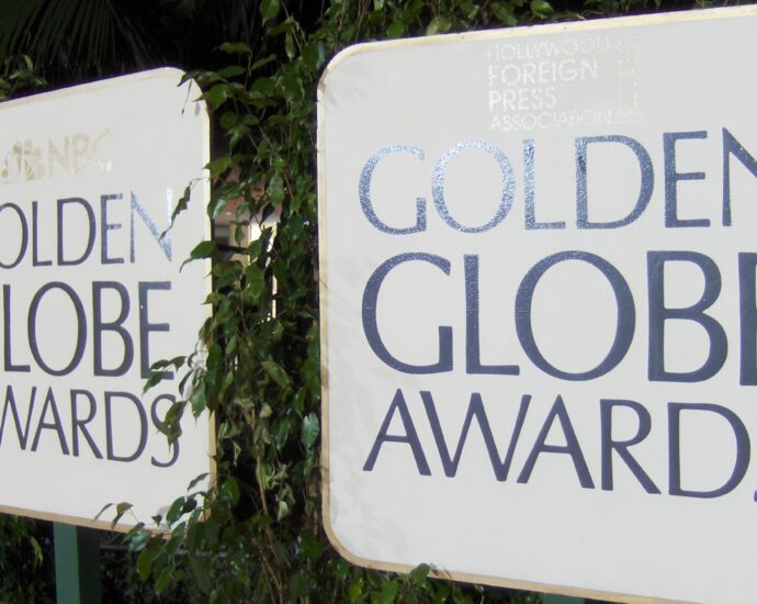 Two white signs with the words Golden Globe Awards on them.