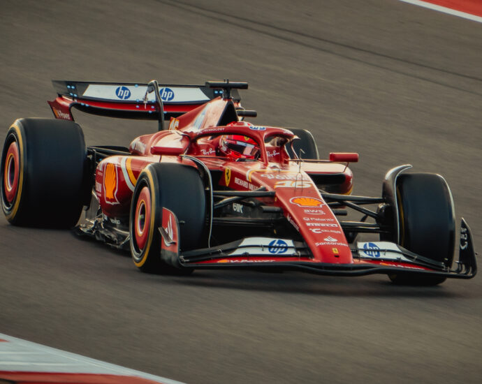 Red Formula 1 car on a track, heading towards the camera