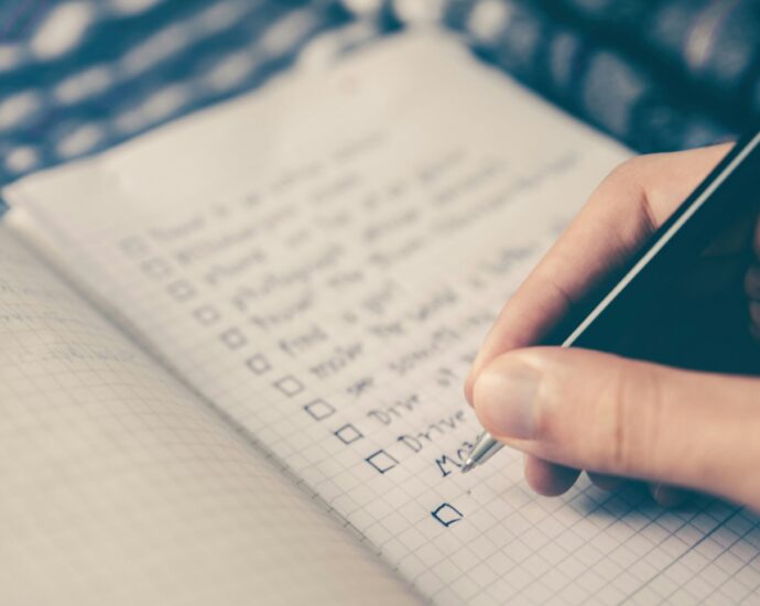 A long list of New Year's Resolutions being written in a notebook