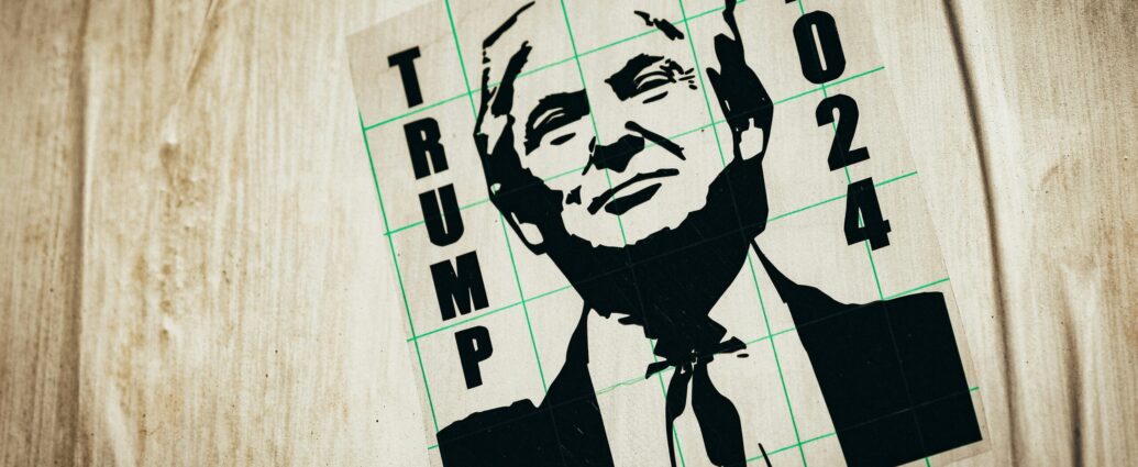 A black ink drawing of Donald Trump with the words 'Trump 2024' on a wooden surface.