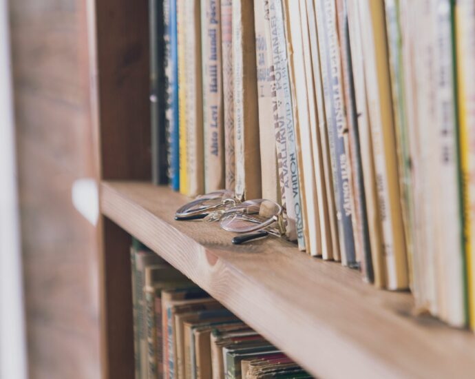A pair of glasses on a bookshelf